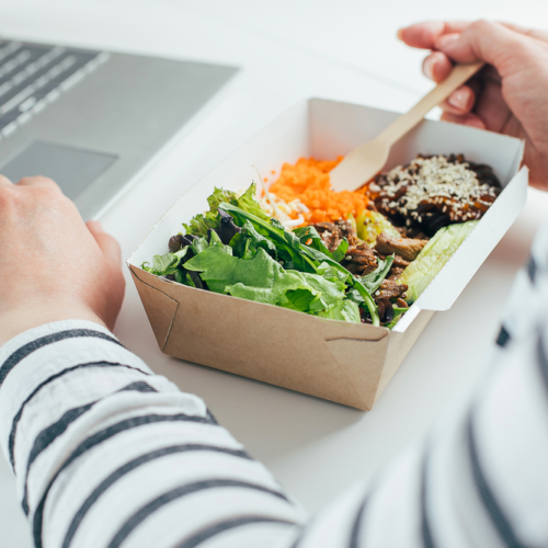 Eating lunch at work infront of computer | Swoosh Finance