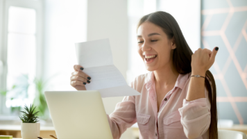 A girl celebrating because she was just approved for a loan | Swoosh Finance