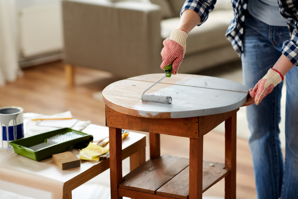 Coating a wooden table in paint to repurpose the piece to make the table look new at a cheaper cost | Swoosh Finance