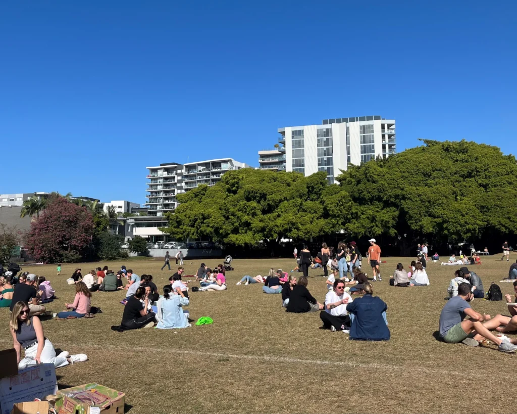 Alot of people having picnics in the Brisbane Park | Swoosh Finance