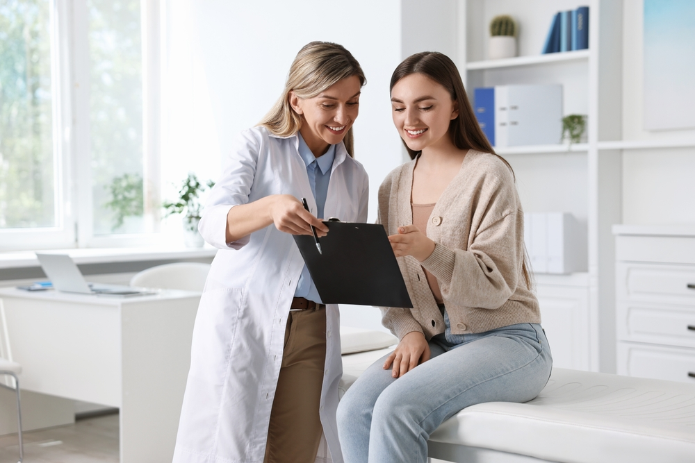 Doctor and Patient looking over medical bill | Swoosh Finance