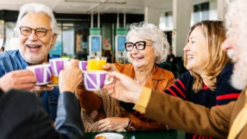 what is superannuation; group of friends toasting drinks | Swoosh Finance