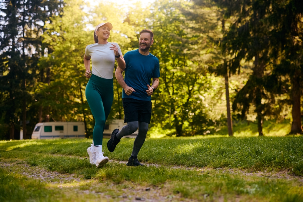 Couple jogging in the park | Swoosh Finance