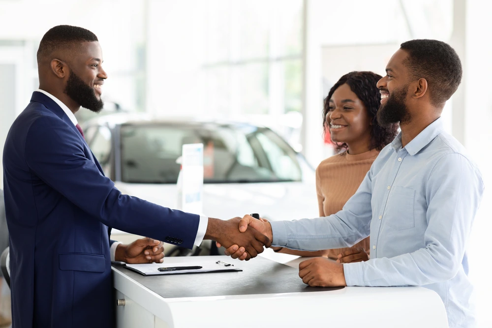 Shaking hands after doing a deal for a car | Swoosh Finance