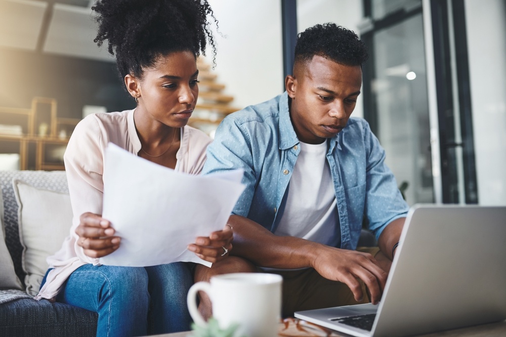 Serious couple checking their credit scores | Swoosh Finance