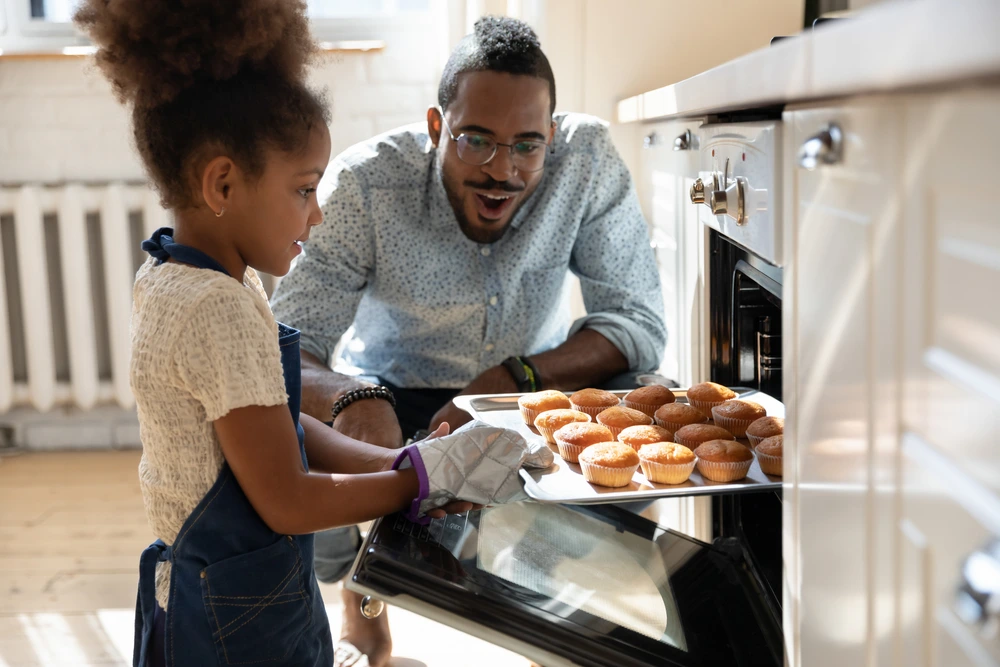 Dad and Daughter baking homemade cupcakes for their family | Swoosh Finance