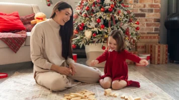 Mum and Daughter playing blocks on Christmas morning | Swoosh Finance