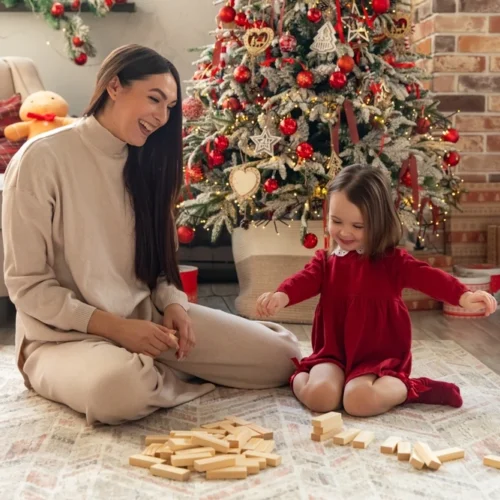 Mum and Daughter playing blocks on Christmas morning | Swoosh Finance