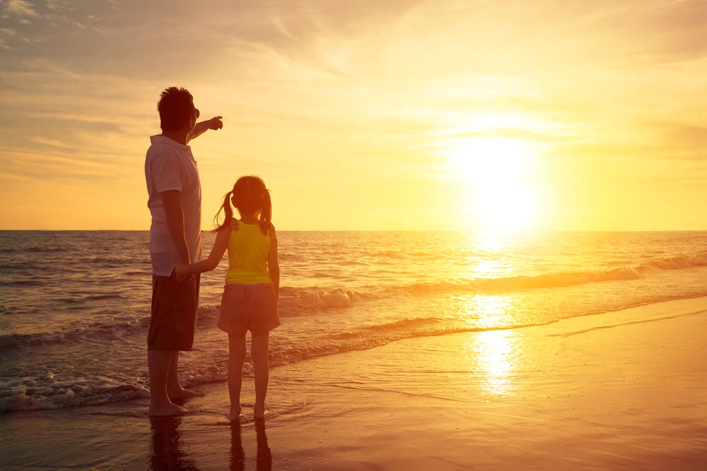 Dad and daughter watching the sunrise