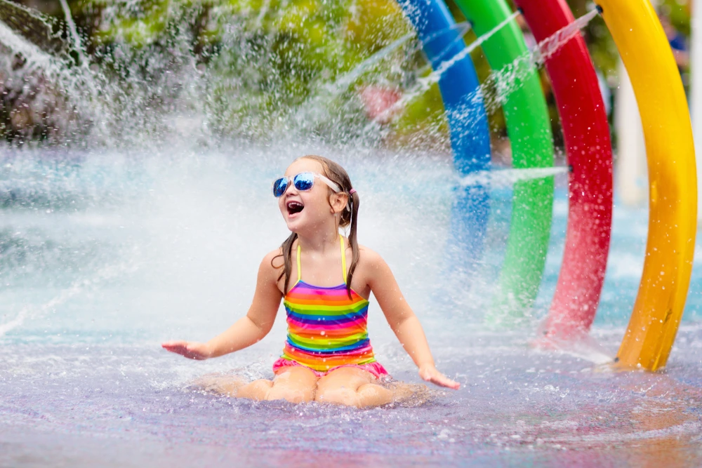 Kid at a waterpark enjoying her school holidays | Swoosh