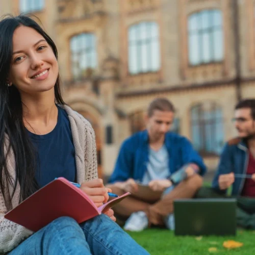 Uni student working on the grass | Swoosh Finance